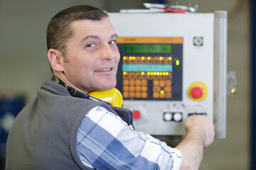 electrician checking electrical box looking at camera