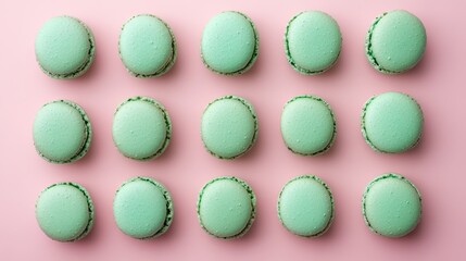 Fototapeta premium Mint macaroons in a row on pink background,french macaroons,Paris Pastry macaron green tea,Pastry shop card with copy space,french macaroons,bakery and branding concept,copy space.