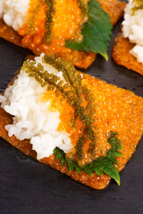 Inari sushi with caviar, rice, shiso and umibudo