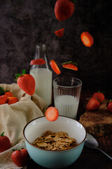 still life bowl of red ripe strawberries on a dark background