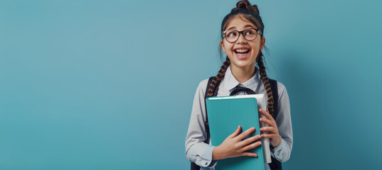 Excited Schoolgirl with Braided Hair Holding Math Book and Calculator on Light Blue Background