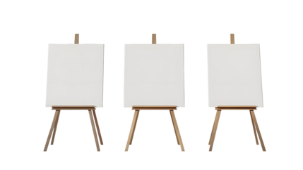 Three blank canvases on easels in a white room with natural light.
