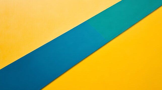This abstract background features a diagonal line dividing a yellow surface with a blue and green surface. The image symbolizes simplicity, contrast, geometry, division, and modern design.