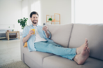 Photo of handsome bearded alone mature age adult man staying home in living room with huge couch...