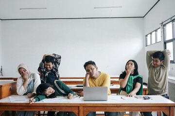 Multiethnic Asian Students Listening A Boring Lesson Sitting In A Desk At Classroom