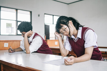 Anxious Young Asian Students Holding Their Head Stressed Doing Exam That They Don't Know The Answer