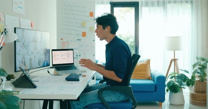 Young freelance Asia male use laptop talk to colleague plan in video call meeting on desk in living room at home office. Work from house, financial plan, remotely digital nomad job and Gen Z talent.