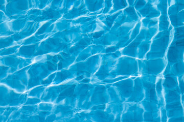 Obraz premium Blue Water Pool Surface with Sunlight Reflections