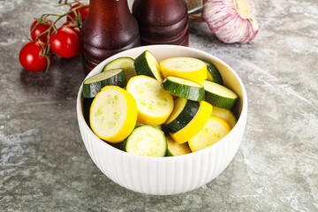 Sliced raw young green and yellow zucchini