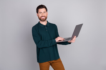 Photo of successful attractive nice man manager wear trendy green clothes use gadget isolated on gray color background