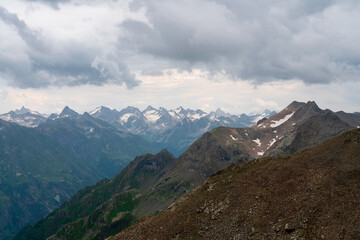 Naklejka premium View of the Great Caucasian Ridge opening from the Upper station of the cable car system of the Dombay ski resort on a summer day, Karachay-Cherkessia, Russia