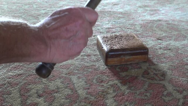 A hand with a hammer and gavel in a courtroom