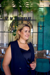 a middle-aged plus size woman in old money style clothes in a fancy restaurant