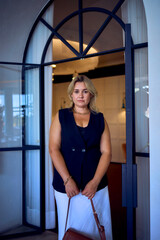 a  middle-aged plus size woman in old money style clothes in a fancy restaurant