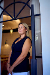 a  middle-aged plus size woman in old money style clothes in a fancy restaurant