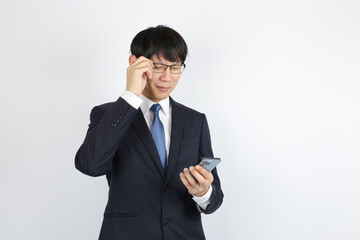 スマートフォンを弄るビジネスマン