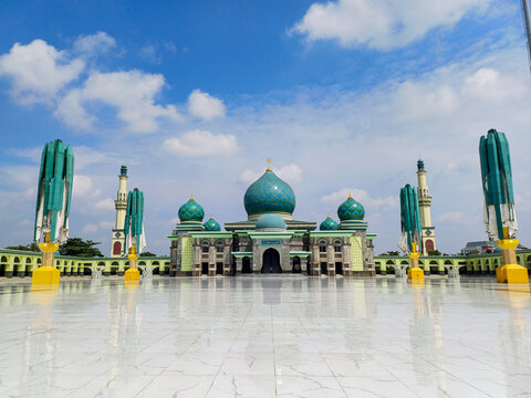 An-Nur Great Mosque, a grand mosque in Pekanbaru, Riau, Indonesia. Among the largest in the country, captured on 29th August under a blue, semi-cloudy sky, highlighting its architectural magnificence