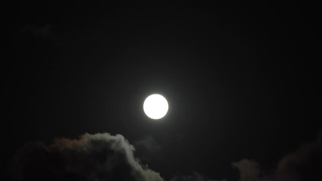 Full moon and moving clouds at night. Mystery or scary or halloween concept 4k video.
