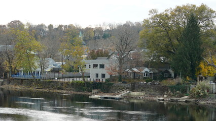 Fototapeta premium The beautiful little town landscape with the colorful autumn leaves and old buildings in USA