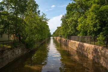 View of the Obvodny (Admiralteysky, Wired) Canal along Sovetskaya Street on a sunny summer day, Kronstadt, St. Petersburg, Russia