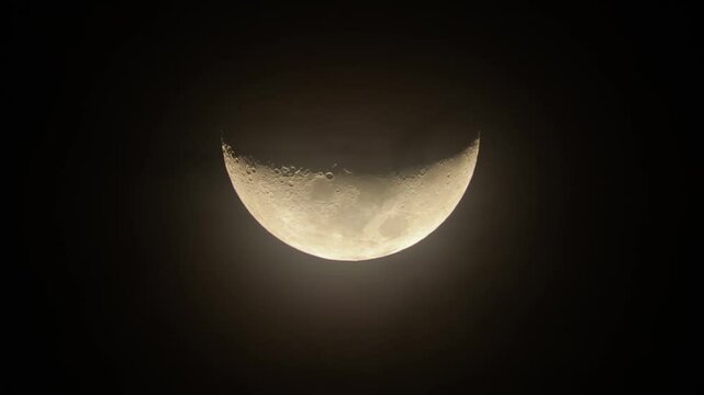Waxing crescent in the dark night sky. Crescent Moon with "horns" up. Shooting through a telephoto lens, close-up