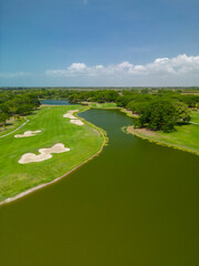 Golf course sport, green grass, lake and trees on a golf field, fairway and putting green top view. - stock photo