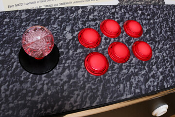 Leeds England: 2nd June 2024: classic arcade setup displays a joystick and six vibrant red buttons, inviting players to engage in classic fighting games