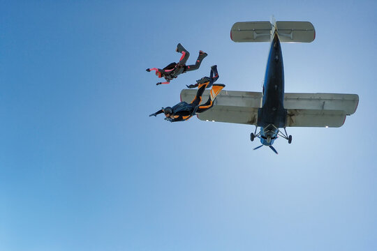 Three skydivers jump out of the plane