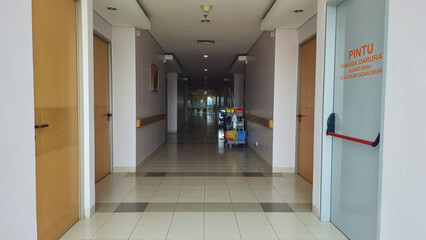 Empty hospital corridor with cleaning equipment