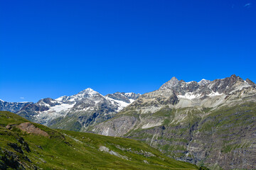 Swiss Alps peaks and ridges covered in snow in Summer. 
