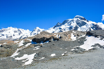 Swiss Alps peaks and ridges covered in snow in Summer. 