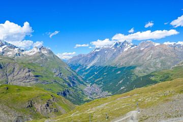 Swiss Alps peaks and ridges covered in snow in Summer. Stunning mountain landscape in Switzerland. Panoramic shot. Space for copy. 