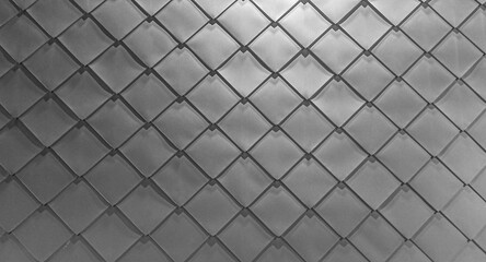 grey Wall texture of metal gray plates. Square rhomb  tin on the wall. The walls are covered with silver sheet metal. Wall and roof protection.