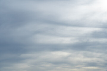 Dramatic rain clouds sky background. Gray clouds in the sky blocking the sun. Rain storm cumulus...