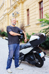 man stay at motorcycle with helmet. Auto mechanic, car service, car rental, motorcycle rental. 