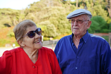 Elderly couple socializing with friends outside