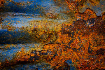 Rusty metal surface with shabby background paint. Blue cracked paint texture on an iron sheet. Fragment of an old metal door, Metal corrosion.