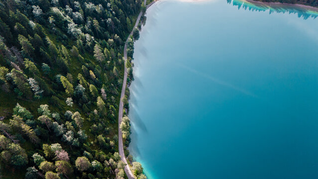 Aerial view of turquoise water and lush greenery at Plansee in Austria during sunny weather
