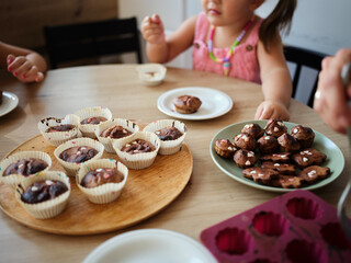 Children enjoying homemade baked goods at a family gathering in a cozy kitchen during a sunny afternoon