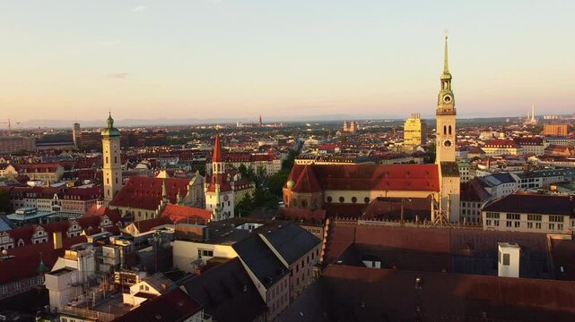 Slow Descent Over Munich at Sunrise with Heilig Geist, St. Peter, and Distant Mountains