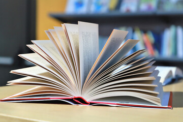 stack of books on the table. open books on the table. close-up of a fanned book