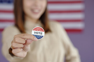 Close-up of young voter holding patriotic pin
