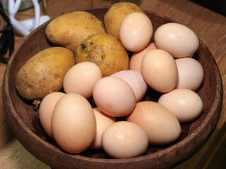 Eggs in a wooden bowl on a table in the kitchen