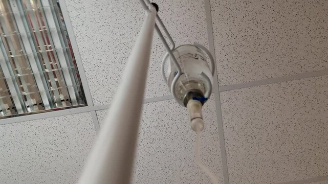 Drip administration of saline solution during hospital treatment. Soft focus. Intravenous infusion drops. During the procedure, the liquid is in the vial.