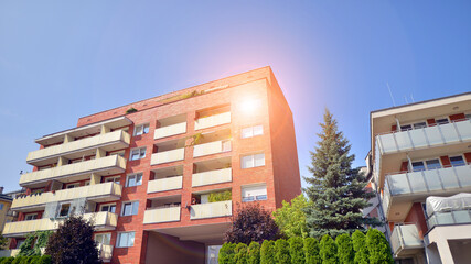 Low angle view apartment building  from the beginning of the 21st century. Architectural elements of apartment building. Green surroundings of buildings. Ecological housing estate.