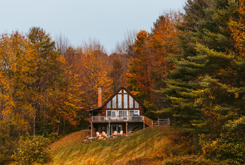 Cabin in the Woods Cloudy Day in Autumn in New England. Fall Foliage Colorful Trees.