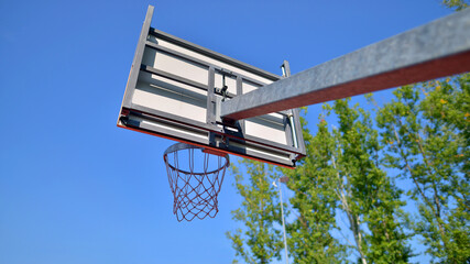 Schoolyard with basketball court and school building exterior in the sunny day.  © Grand Warszawski