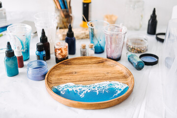 Creating stunning epoxy resin art with vibrant colors and textures for a coastal-themed serving...