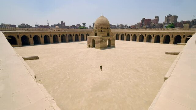 Aerial View Of A Man At The Mosque Of Ibn Tulun Open Square Courtyard In Cairo, Egypt.