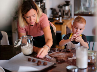 A mother and son enjoy baking together in a cozy kitchen, preparing cookies and bonding on a sunny afternoon